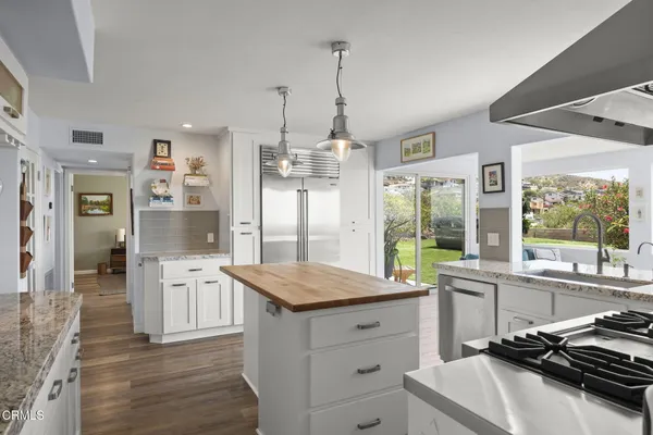 a spacious bedroom with a large bed a mirror and a desk