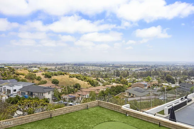 a view of balcony with wooden floor and outdoor seating