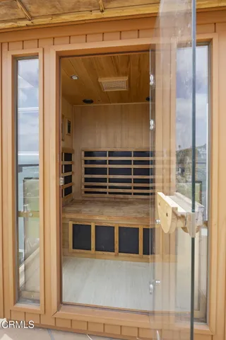 a large bed sitting in a room next to a window