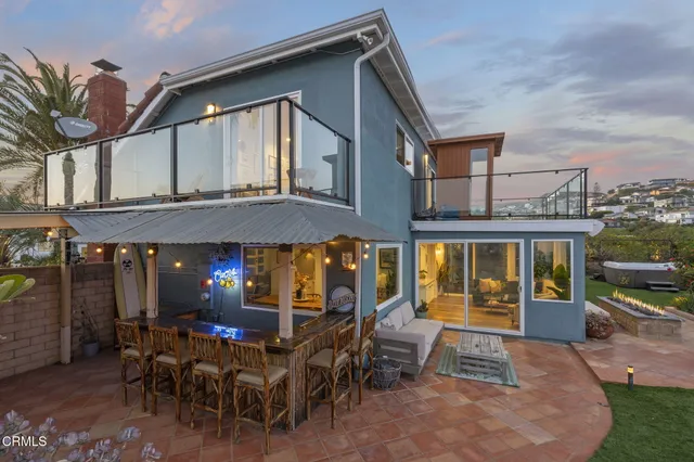 a view of a cafe with a table and chairs under an umbrella