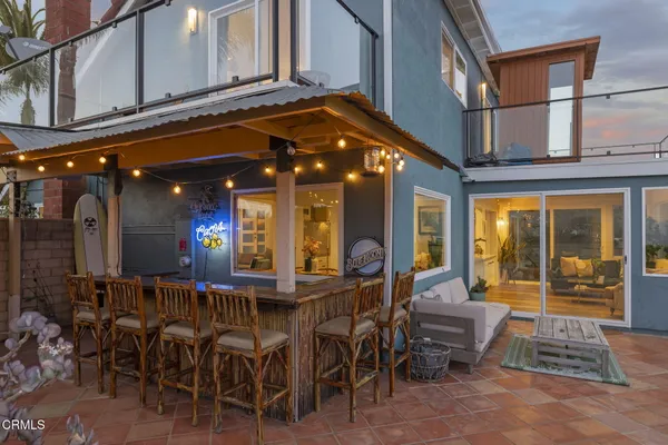 a view of a patio with a table chairs and a yard