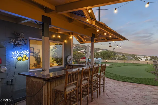 an aerial view of a house with garden space and lake view