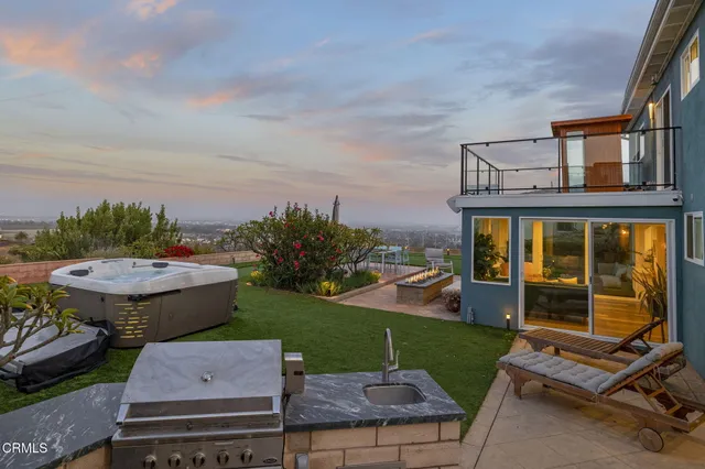 a view of a patio with couches table and chairs and potted plants
