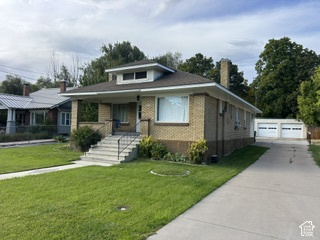 481 East Center Street Logan, UT 84321 - Photo 23 of 23 Brick exterior with a covered porch, concrete driveway, and a detached two-car garage