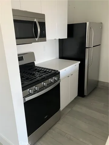 a kitchen with a stove and a refrigerator