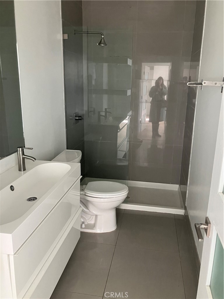 8811 Burton Way, Unit 202 Los Angeles, CA 90048 - Photo 10 of 19 a bathroom with a toilet and shower