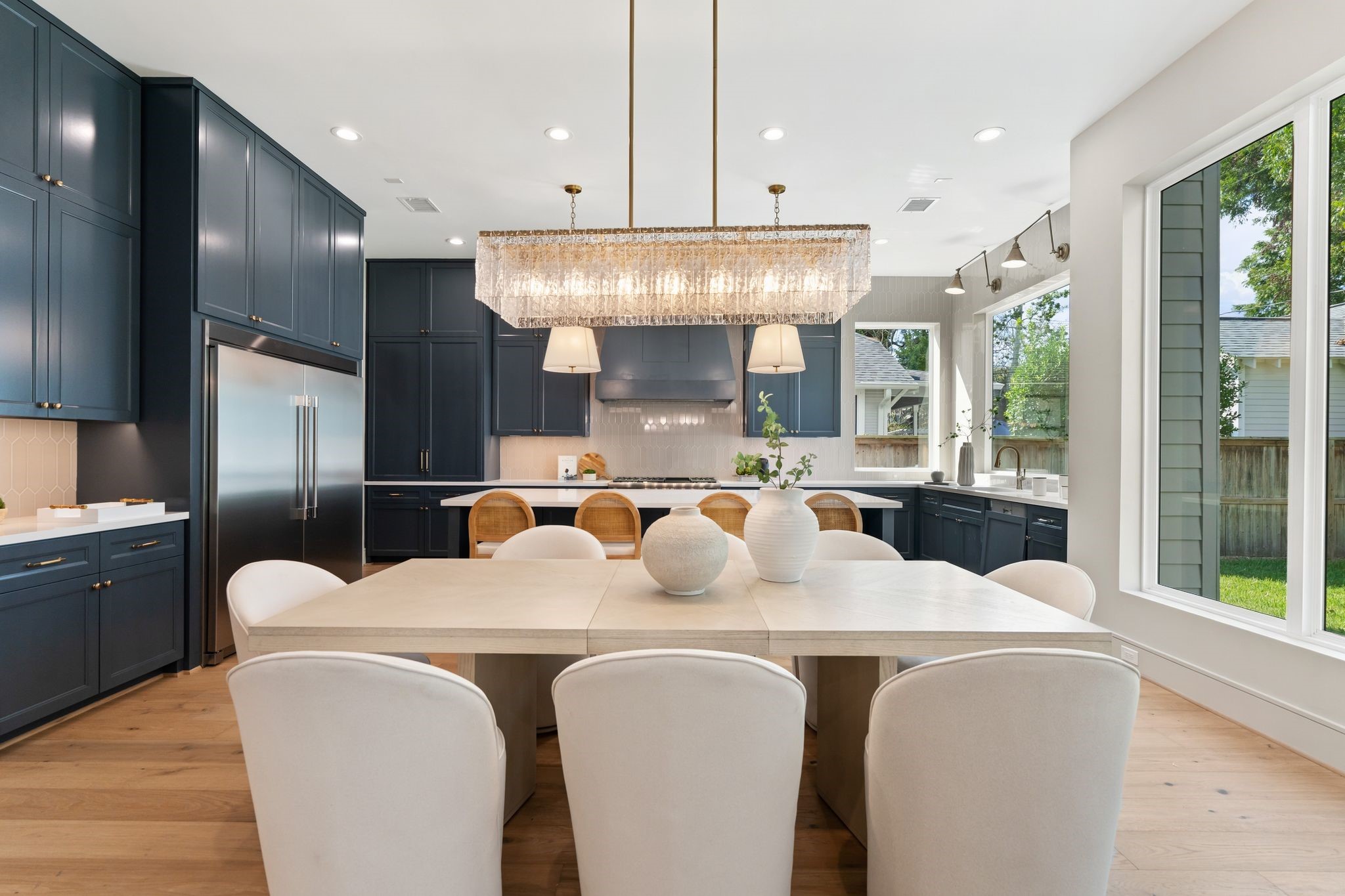 711 East 12th Street Houston, TX 77008 - Photo 17 of 47 The dining room's open connection to the kitchen’s generous island and the adjoining great room keeps conversation flowing, with warm hardwood floors tying the spaces together.