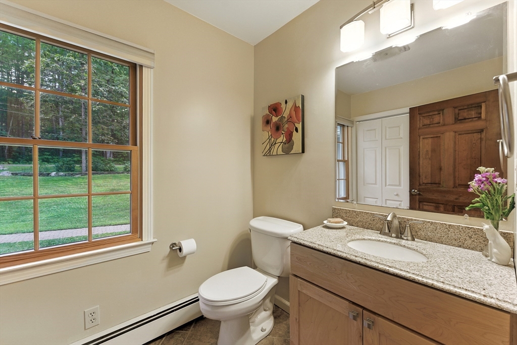 481 Kennedy Road Northampton, MA 01053 - Photo 18 of 40 a bathroom with a granite countertop sink mirror vanity and toilet