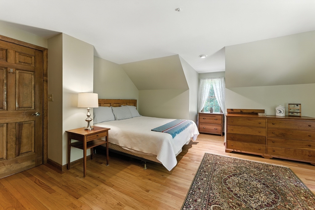 481 Kennedy Road Northampton, MA 01053 - Photo 21 of 40 a bedroom with a bed and a night stand