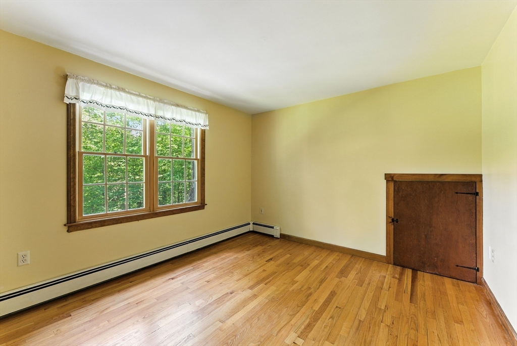 481 Kennedy Road Northampton, MA 01053 - Photo 27 of 40 a view of an empty room with wooden floor and a window