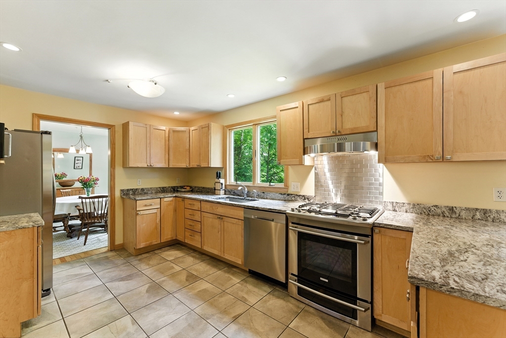481 Kennedy Road Northampton, MA 01053 - Photo 6 of 40 a kitchen with granite countertop a stove top oven sink and cabinets