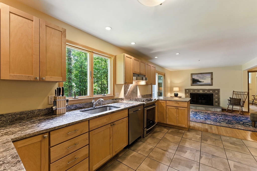481 Kennedy Road Northampton, MA 01053 - Photo 8 of 40 a kitchen with stainless steel appliances granite countertop a stove sink and microwave
