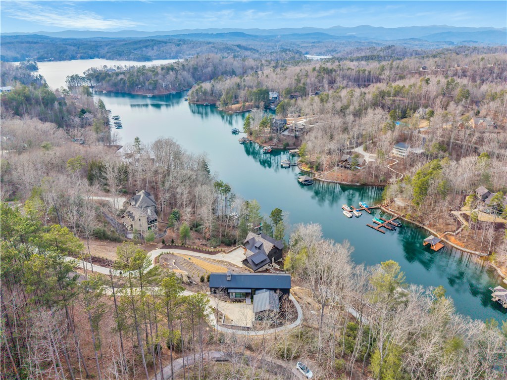 127 Crosswind Court Sunset, SC 29685 - Photo 4 of 49 This aerial view showcases a tranquil lakefront community nestled amidst lush woodlands and rolling hills.