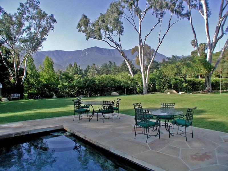 a view of a chairs and table in the yard