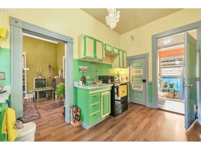 a kitchen with cabinets and wooden floor
