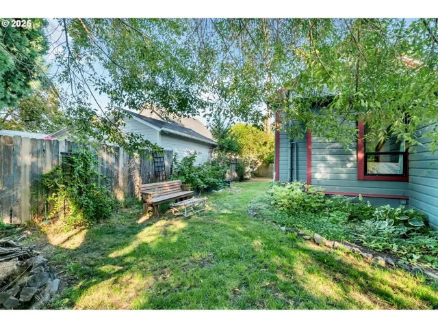 a view of a house with a tree and plants