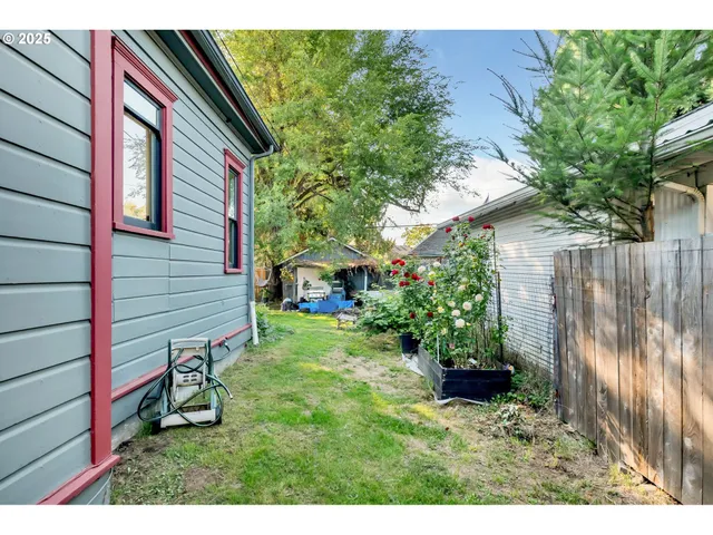 a backyard of a house with a garden and plants