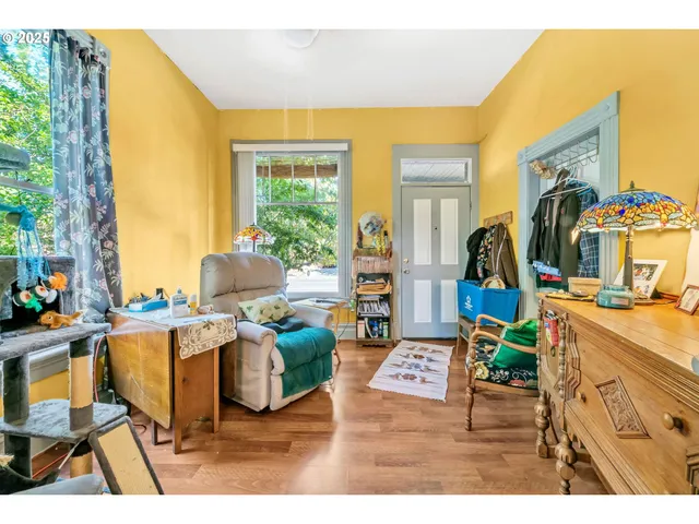 a living room with furniture and a floor to ceiling window