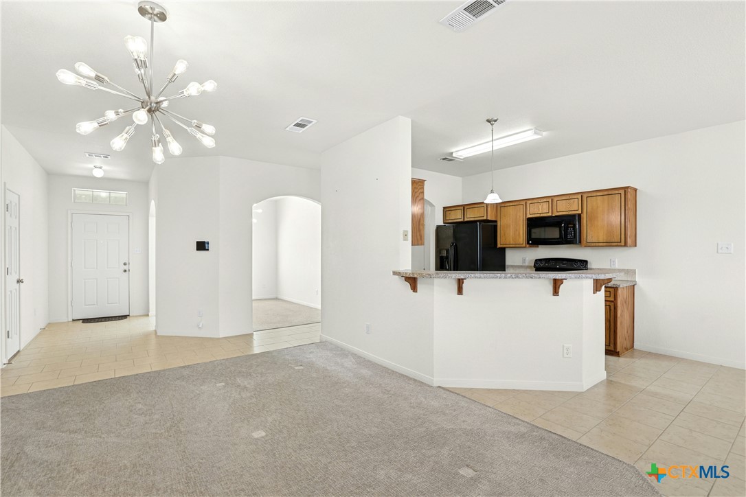 3203 Canadian River Loop Killeen, TX 76549 - Photo 11 of 27 a view of a livingroom with kitchen appliances and furniture