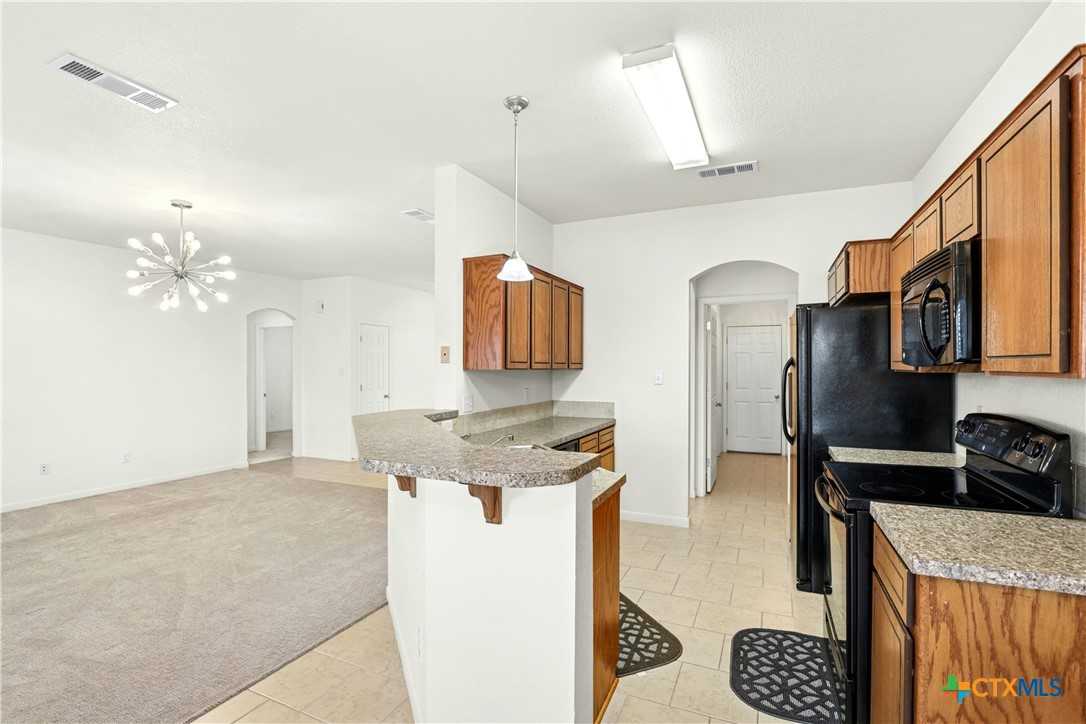 3203 Canadian River Loop Killeen, TX 76549 - Photo 12 of 27 a view of a kitchen counter space and wooden floor