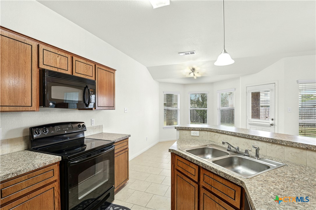 3203 Canadian River Loop Killeen, TX 76549 - Photo 14 of 27 a kitchen that has a sink and a stove