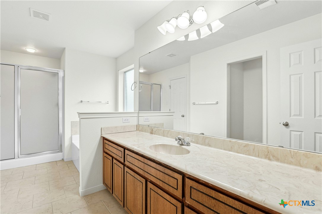 3203 Canadian River Loop Killeen, TX 76549 - Photo 17 of 27 a bathroom with a sink a vanity and a mirror
