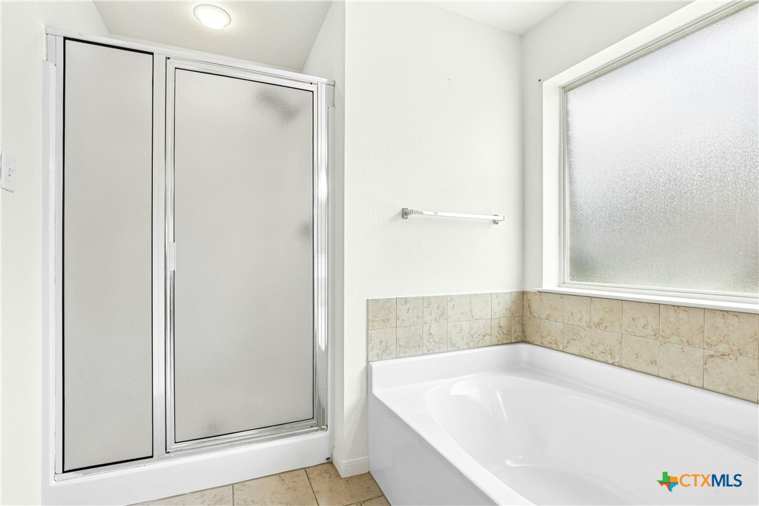 3203 Canadian River Loop Killeen, TX 76549 - Photo 19 of 27 a white bath tub sitting next to a shower