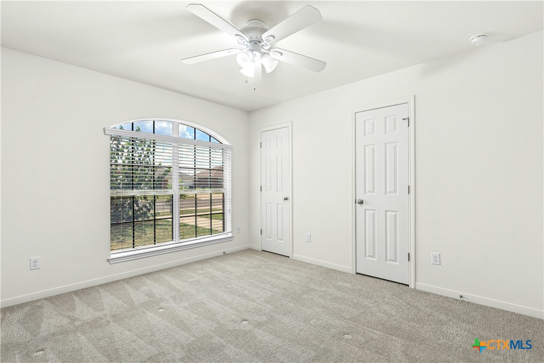 3203 Canadian River Loop Killeen, TX 76549 - Photo 22 of 27 an empty room with chandelier fan and windows
