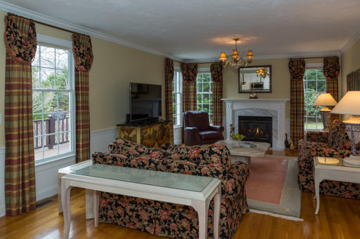 140 Great Marsh Road West Barnstable, MA 02668 - Photo 5 of 30 a living room with furniture a flat screen tv and a fireplace