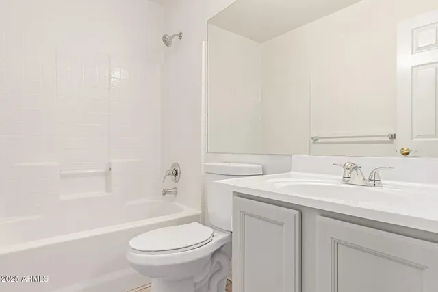 a bathroom with a sink toilet vanity and tub