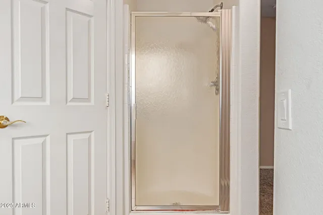 a bathroom with a glass shower door