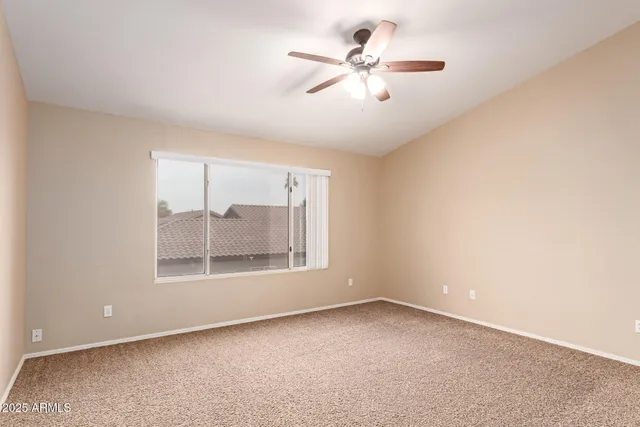 an empty room with a empty space and a ceiling fan