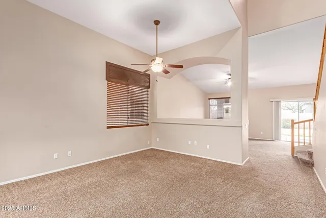 a view of a livingroom with a ceiling fan and window