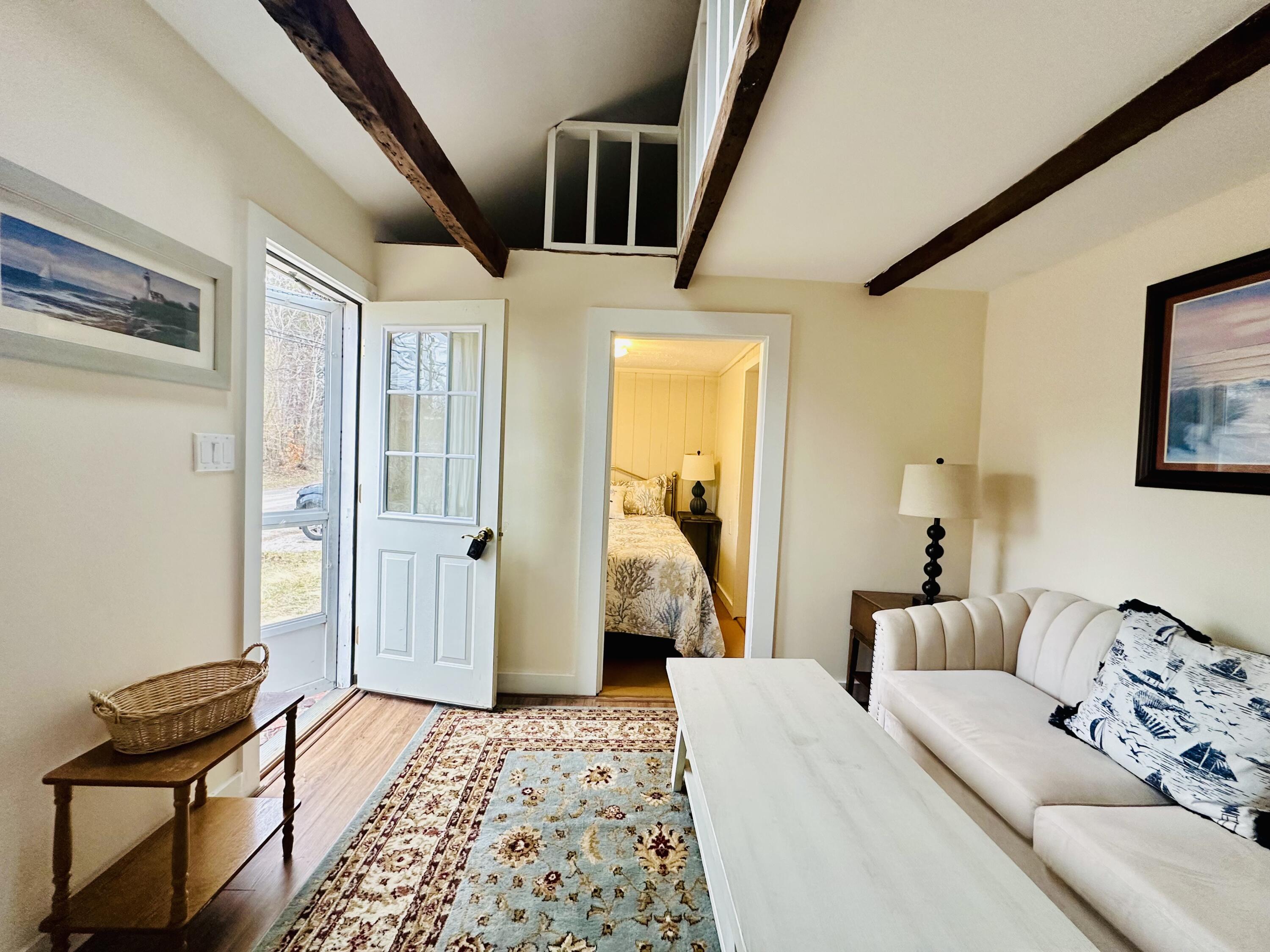 36 Cove Road Wellfleet, MA 02667 - Photo 3 of 22 a bedroom with a bed and wooden floor