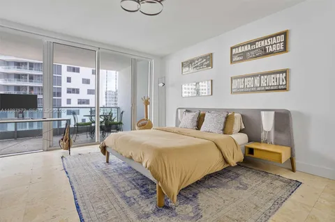 a bedroom with a bed and glass windows