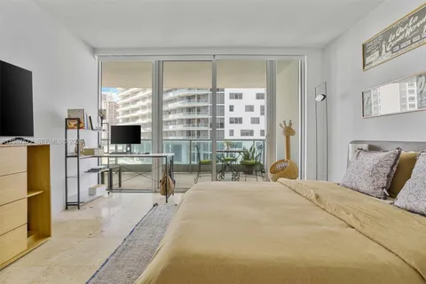 a bedroom with furniture and a flat screen tv