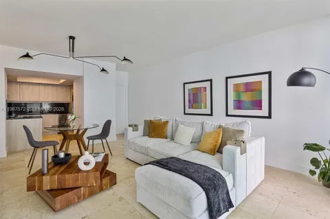 a spacious bedroom with a bed a desk and chair with the wooden floor