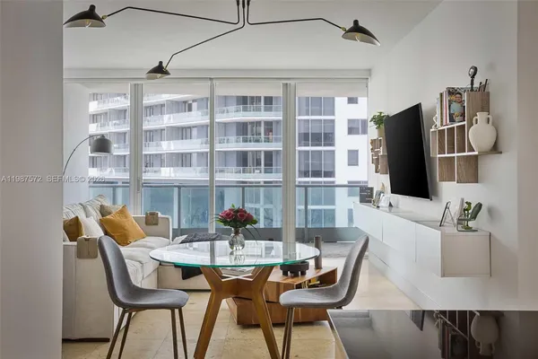 a dining room with furniture and wooden floor
