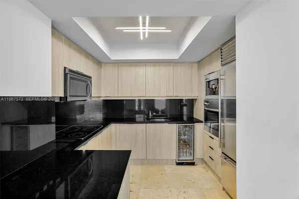 a kitchen with stainless steel appliances kitchen island granite countertop a stove and cabinets