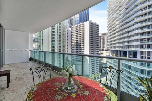 a balcony view with a large window and table in it
