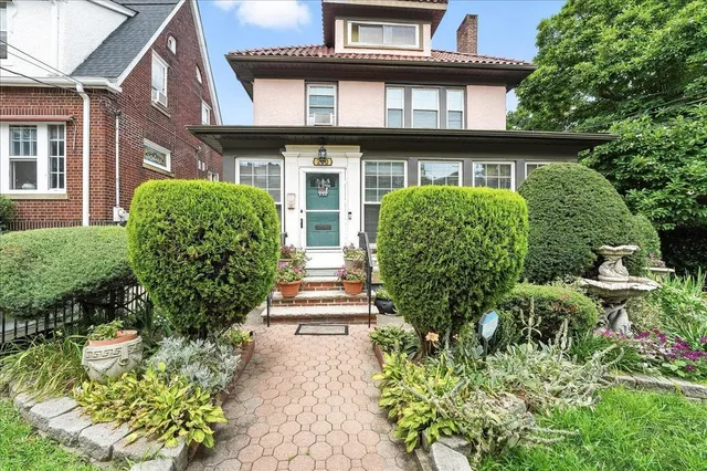 a view of a house with a flower garden