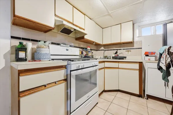 a kitchen with a stove top oven and cabinets