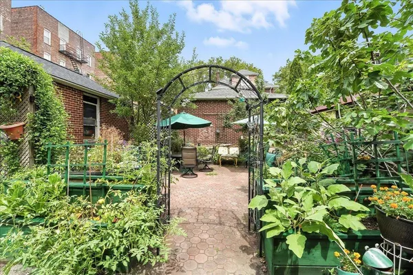 a view of a backyard with plants and a garden