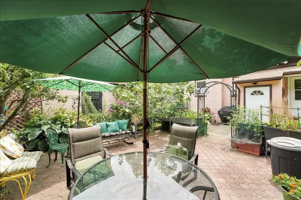 a view of table and chairs under an umbrella