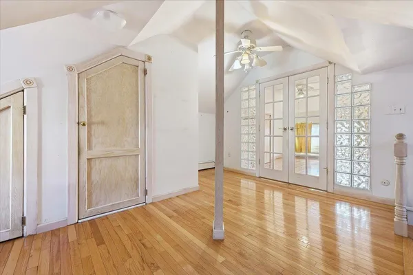 a view of a hallway with wooden floor