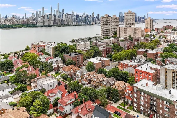 an aerial view of a city with lots of residential buildings lake and ocean view