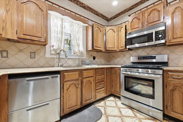 a kitchen with stainless steel appliances a refrigerator and vanity