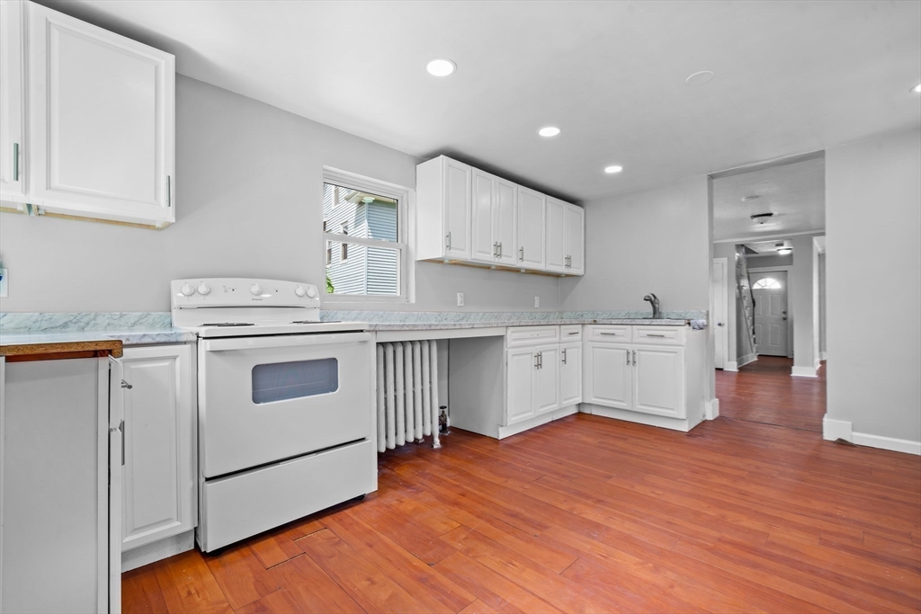 64 Pleasant Street Ware, MA 01082 - Photo 12 of 38 a kitchen with stainless steel appliances granite countertop a white stove top oven and cabinets