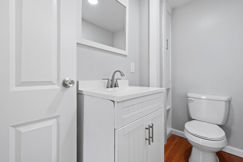 64 Pleasant Street Ware, MA 01082 - Photo 17 of 38 a bathroom with a toilet sink and mirror