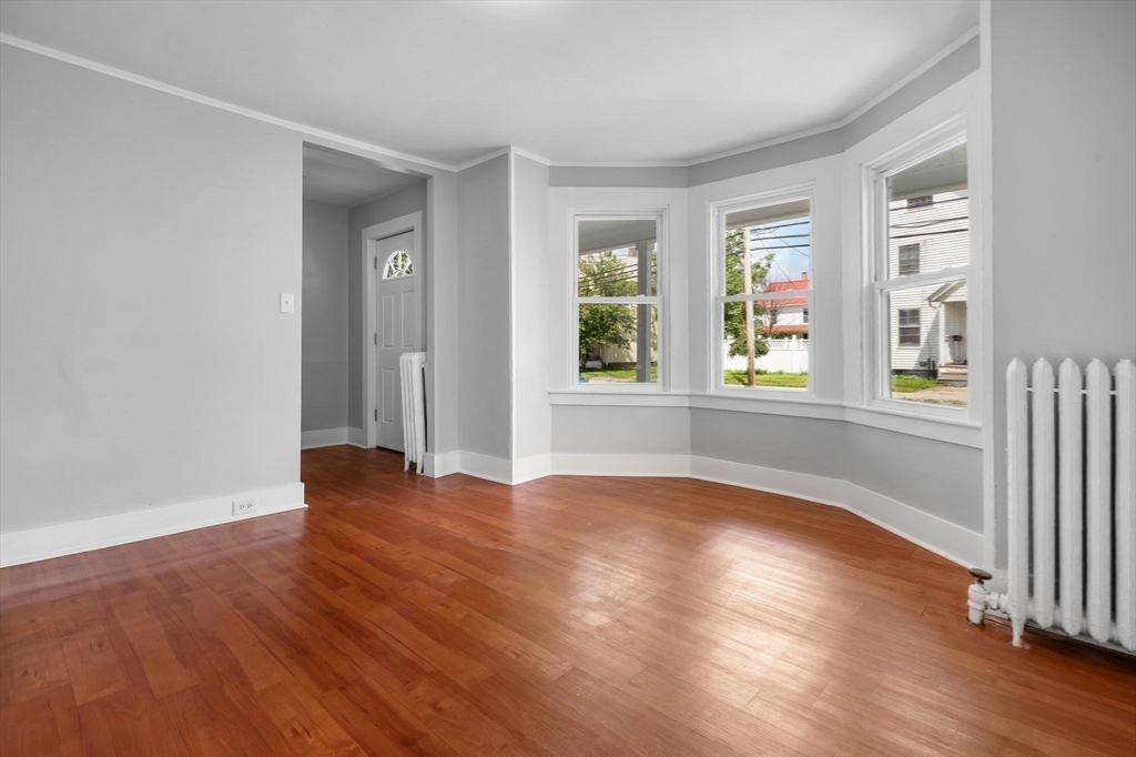64 Pleasant Street Ware, MA 01082 - Photo 24 of 38 an empty room with wooden floor and windows